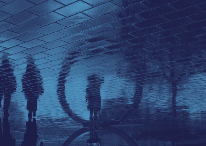 Child custody Bulgaria — human reflections on wet pavement, blue-toned image