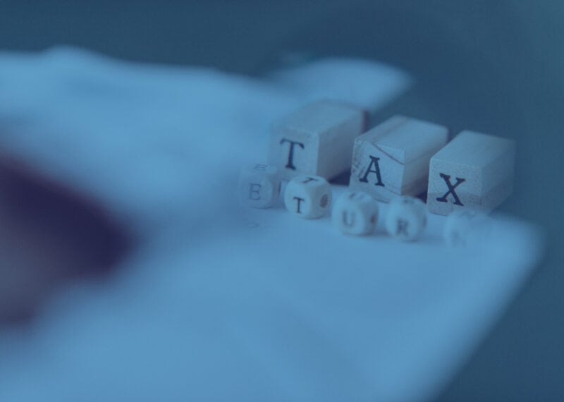Tax appeal in Bulgaria: how to challenge an NRA revision act - blue toned image of wooden cubes spelling tax