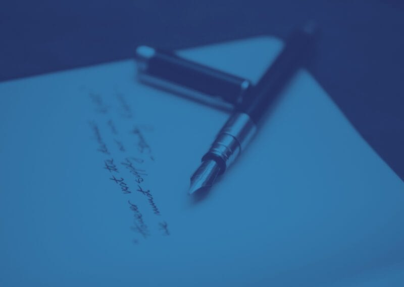 documents and pen illustrating probate in Bulgaria, blue toned image